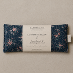 Load image into Gallery viewer, Lavender eye pillow with floral pattern and Karsten &amp; Co. label on a beige background
