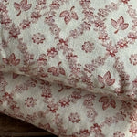 Load image into Gallery viewer, Floral patterned fabric with red flowers on a beige background
