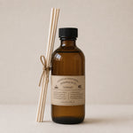 Load image into Gallery viewer, Brown bottle reed diffuser with black cap and reed diffuser on a beige background
