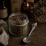 Load image into Gallery viewer, Jar of organic herbal tea on a wooden surface with a candle and spoon in the background - Karsten &amp; Co Australia
