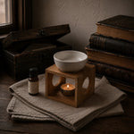 Load image into Gallery viewer, Wooden oil burner with pure essential oil bottle on a wooden surface with books in the background - Karsten &amp; Co. Australia
