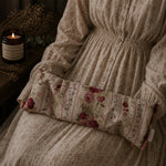 Load image into Gallery viewer, Floral-patterned lupin heat pillow on a textured surface with a candle in the background
