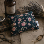 Load image into Gallery viewer, Floral heat pillow with lavender and books on a wooden surface
