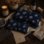 Load image into Gallery viewer, Floral-patterned lupin heat pillows on a wooden surface with a candle and lavender flowers.
