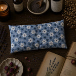 Load image into Gallery viewer, Floral-patterned eye pillow on a wooden surface with lavender and candles
