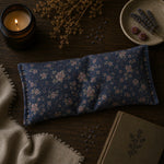 Load image into Gallery viewer, Blue floral eye pillow on a wooden surface with a lit candle and dried lavender - handmade in Australia - Organic Lavender - Karsten &amp; Co.

